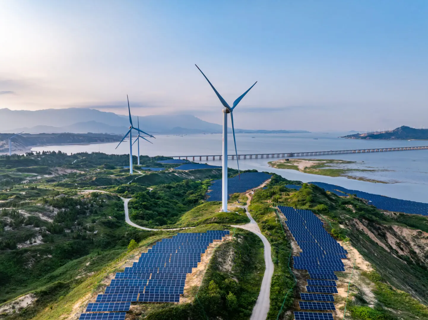 Wind turbines and solar panels on landscape.