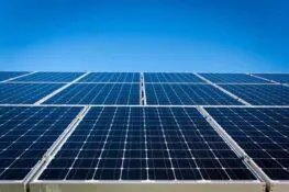 Solar panels under a clear blue sky.