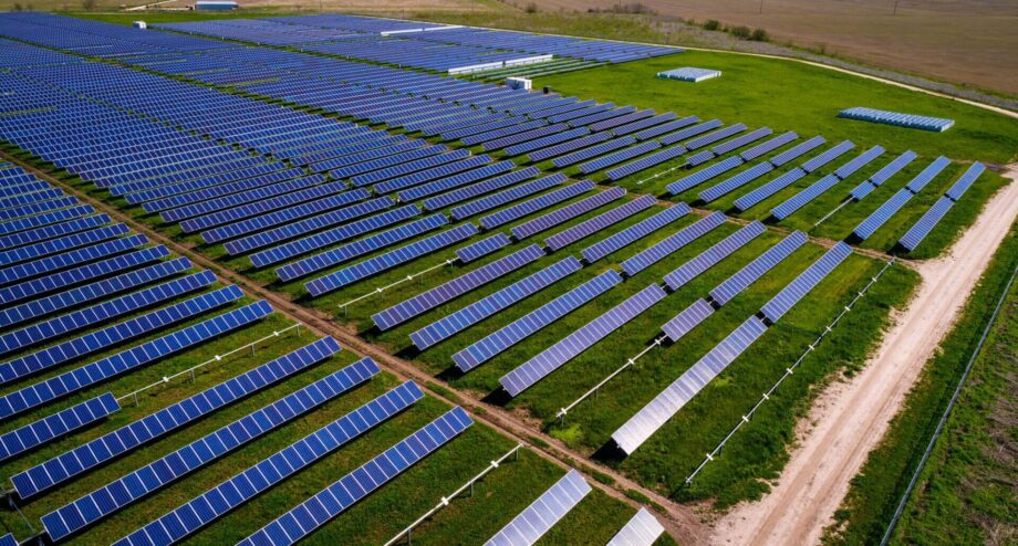 Solar panels in a large green field.
